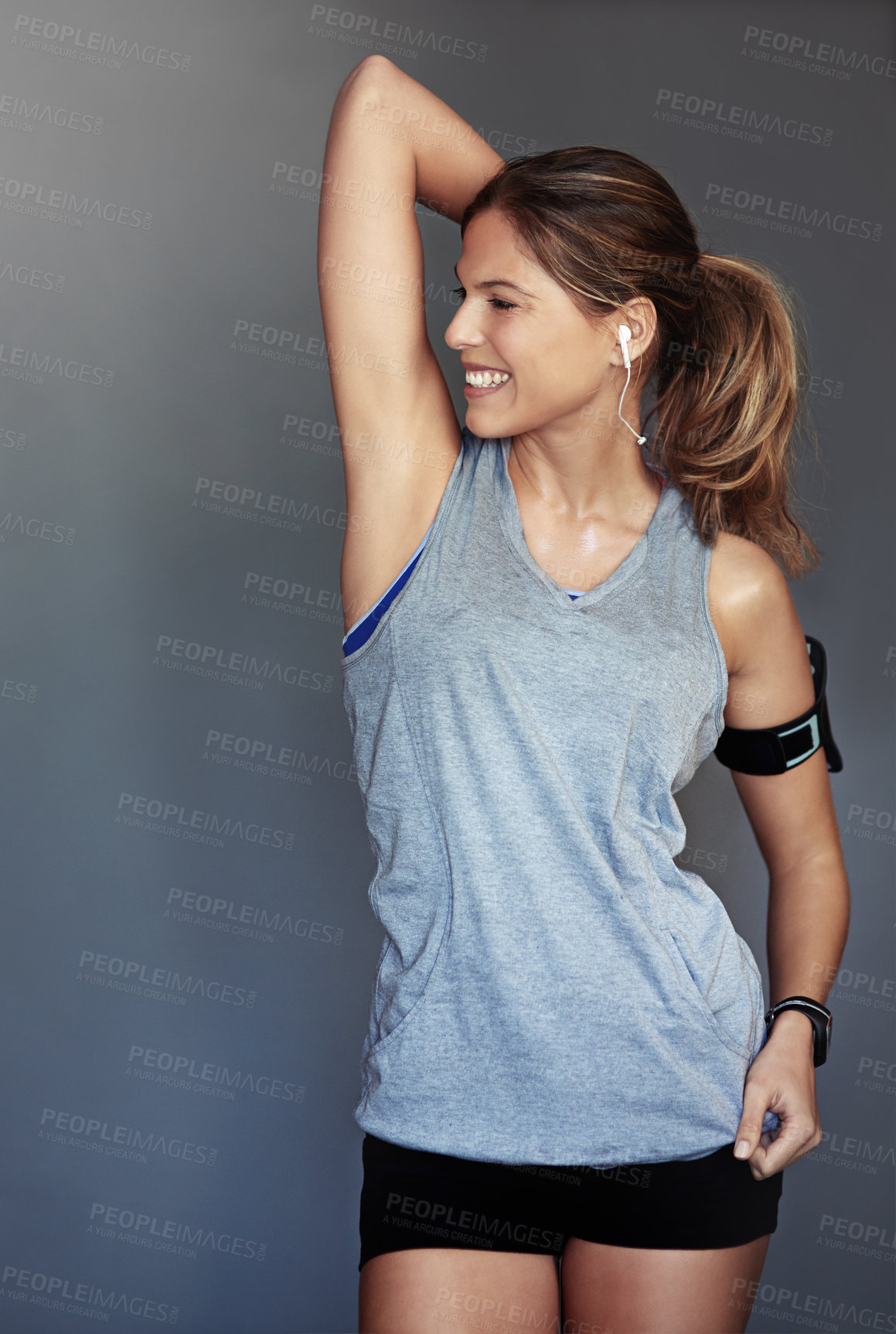 Buy stock photo Studio shot of a sporty young woman posing against a gray background