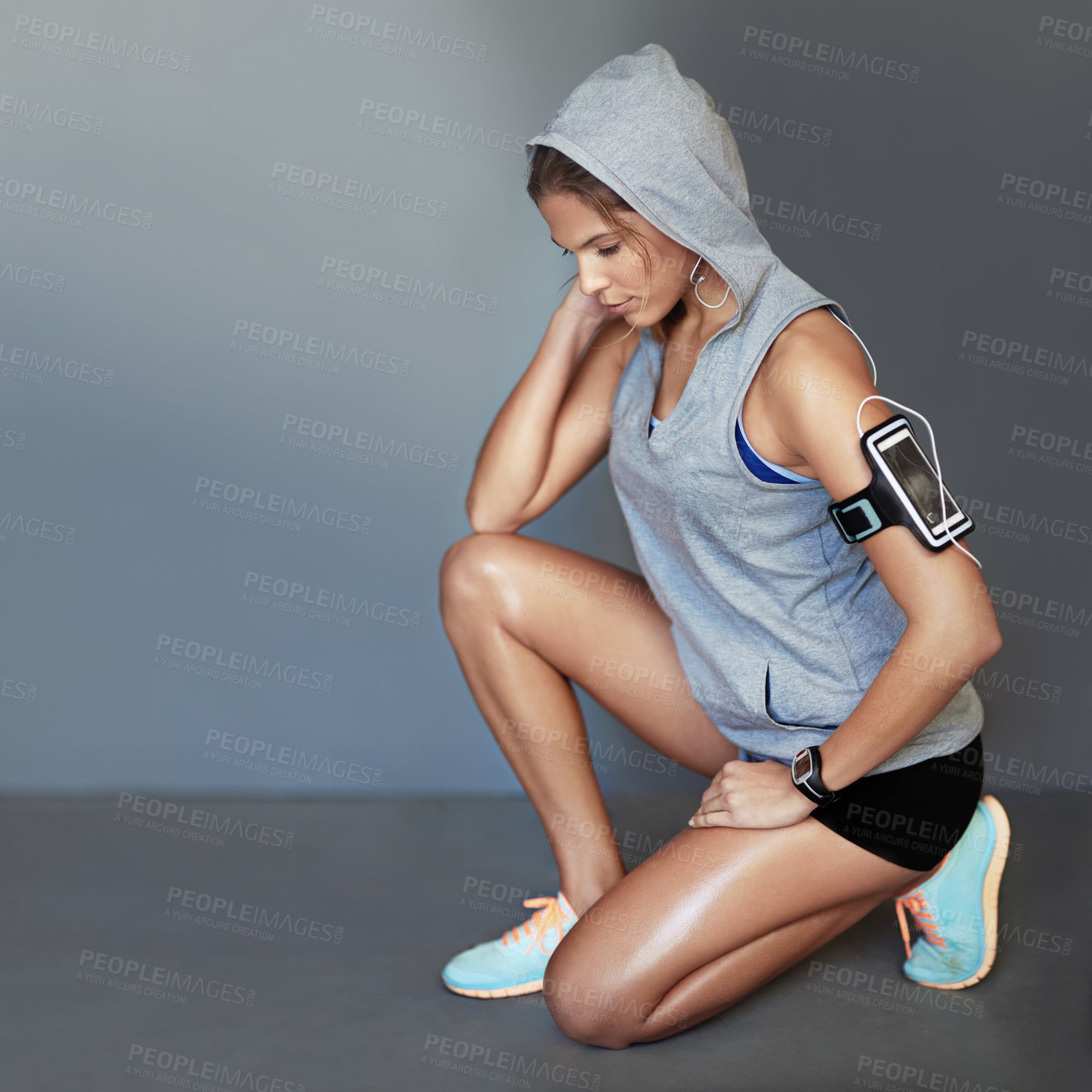 Buy stock photo Shot of a sporty young woman working out against a gray background