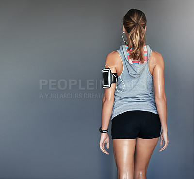 Buy stock photo Rearview shot of a sporty young woman posing against a gray background