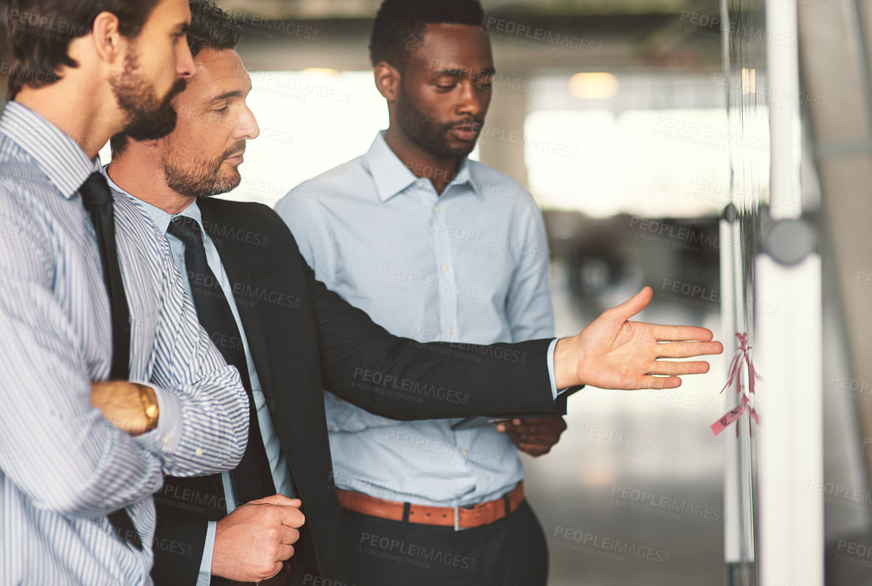 Buy stock photo Thinking, men and discussion with whiteboard in office for planning schedule, information and staff reminder. People, brainstorming and meeting with notes, teamwork and feedback for project proposal