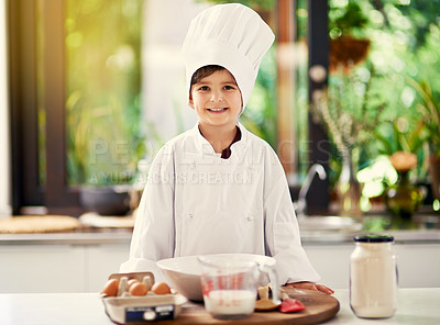Buy stock photo Cropped shot of a young boy cooking in the kitchen
