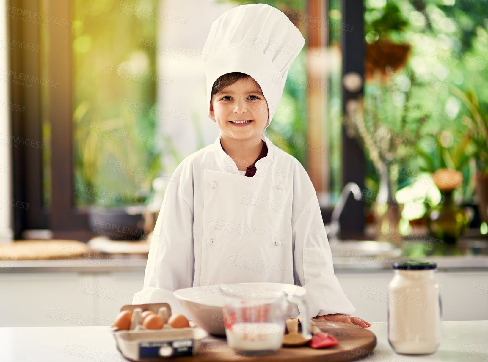 Buy stock photo Cropped shot of a young boy cooking in the kitchen