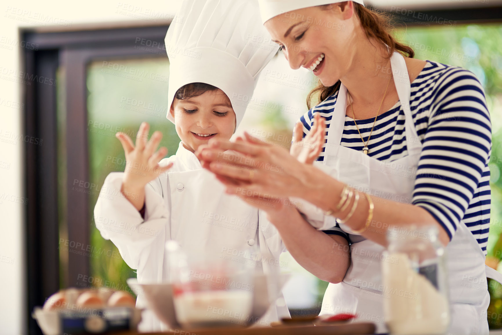 Buy stock photo Kitchen, woman and child with a smile, baking and learning with flour, prepare ingredients and happiness. Mother, home and boy with joy, cooking and playful development with recipe and breakfast help