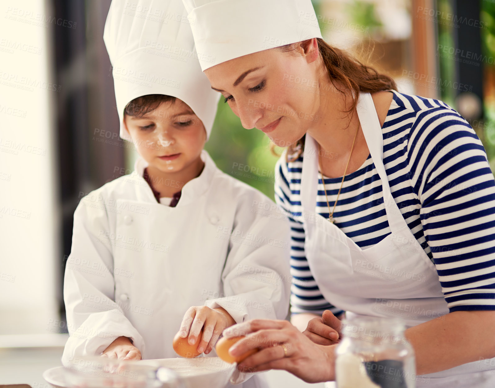 Buy stock photo Kitchen, mom and boy with a smile, baking and learning with eggs, prepare ingredients and happiness. Woman, home and kid with joy, cooking and child development with recipe and breakfast help