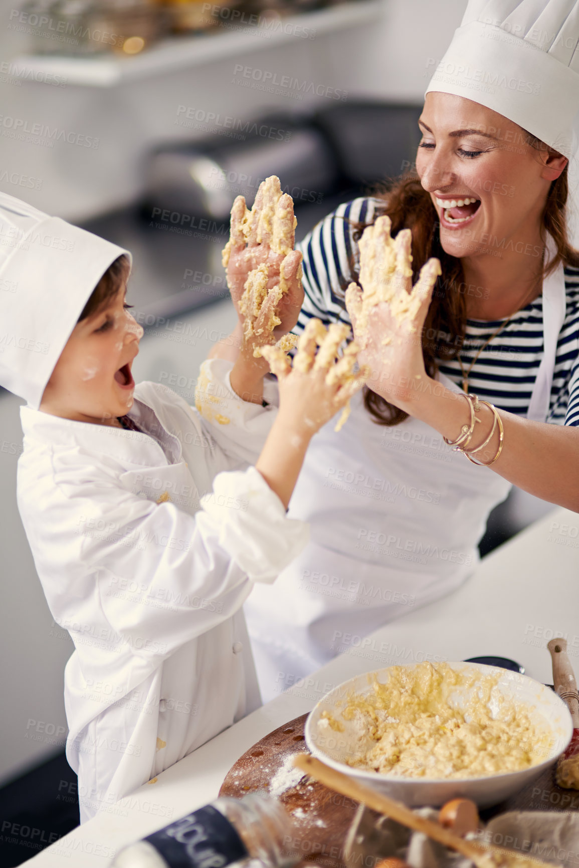 Buy stock photo Kitchen, playful mother and dirty high five, baking and learning with dough, prepare ingredients or culinary skills. Woman, home and kid for joy, cooking and child development for recipe or breakfast