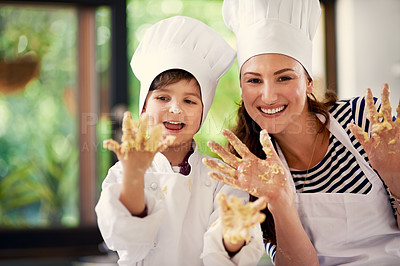 Buy stock photo Shot of a mother and her son playing with cookie dough in the kitchen