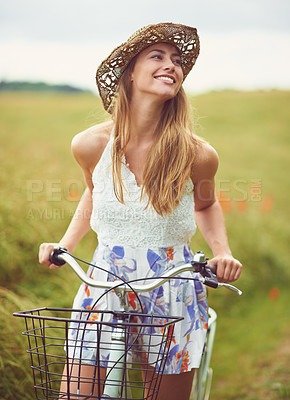 Buy stock photo Thinking, bicycle or happy woman cycling in countryside for holiday, adventure or wellness to relax in nature. Smile, healthy or girl on bike for eco friendly travel, carbon footprint or vacation