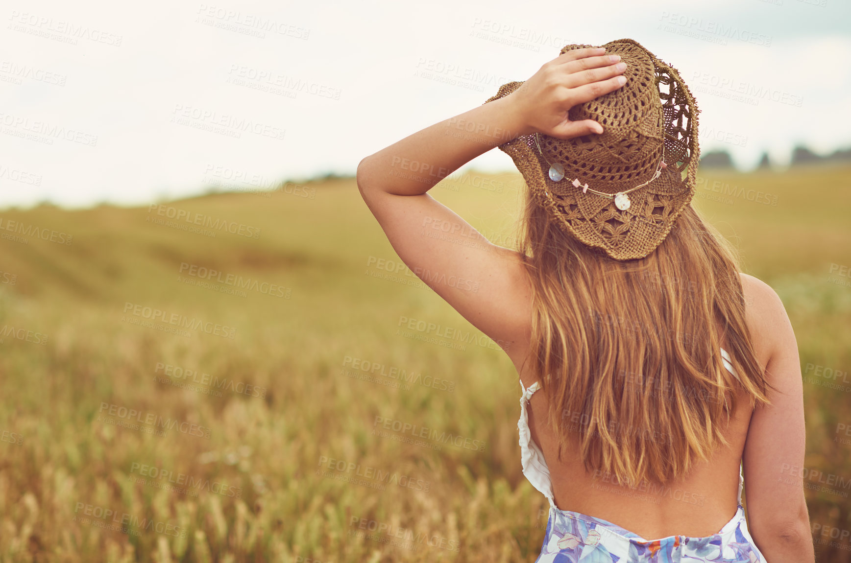 Buy stock photo Back, relax and view with woman in wheat field outdoor for holiday, travel or vacation in summer. Hat, space and wellness with person sightseeing in countryside or nature for calm or peaceful break