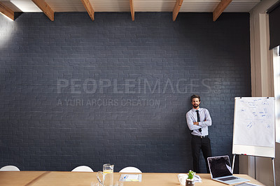 Buy stock photo Portrait of a young businessman standing in the boardroom