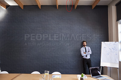 Buy stock photo Portrait of a young businessman standing in the boardroom
