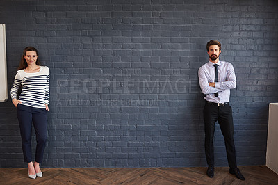 Buy stock photo Portrait of two young businesspeople standing in the boardroom