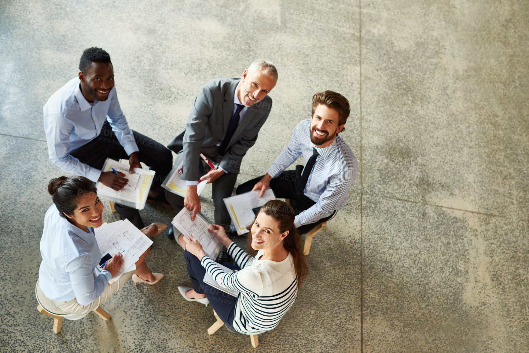 Buy stock photo High angle portrait of a group of coworkers looking up while sitting around in a circle
