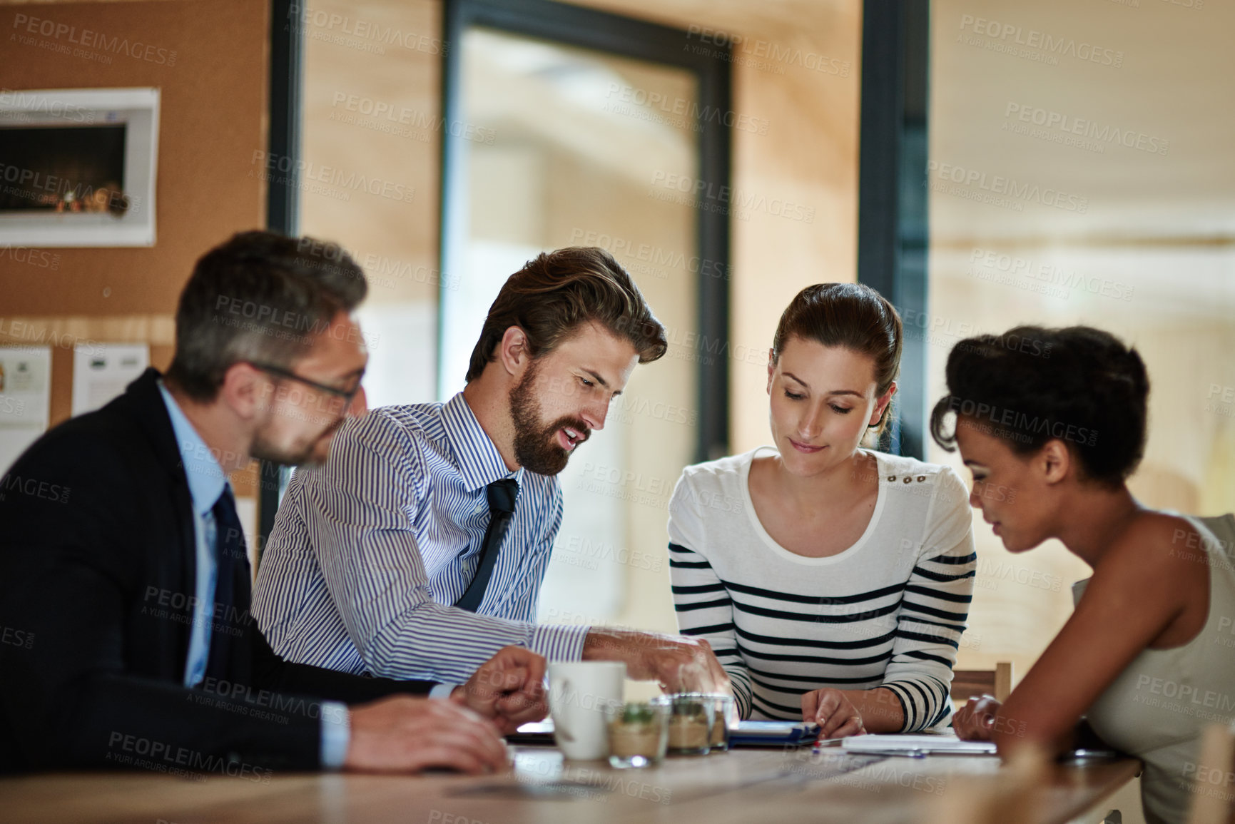 Buy stock photo Shot of a group of colleagues working together in an office
