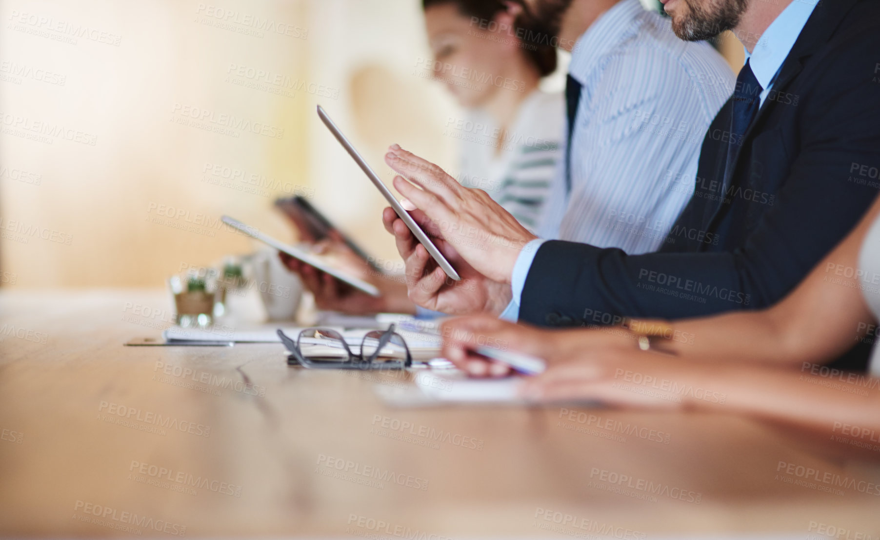 Buy stock photo Shot of businesspeople using their digital tablets during a conference