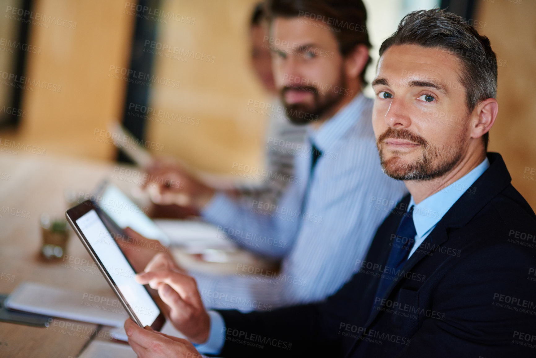 Buy stock photo Portrait of a businessman using a digital tablet during a conference