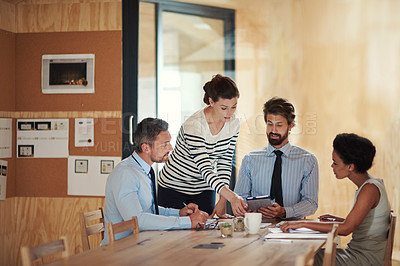 Buy stock photo Shot of a group of colleagues working together in an office