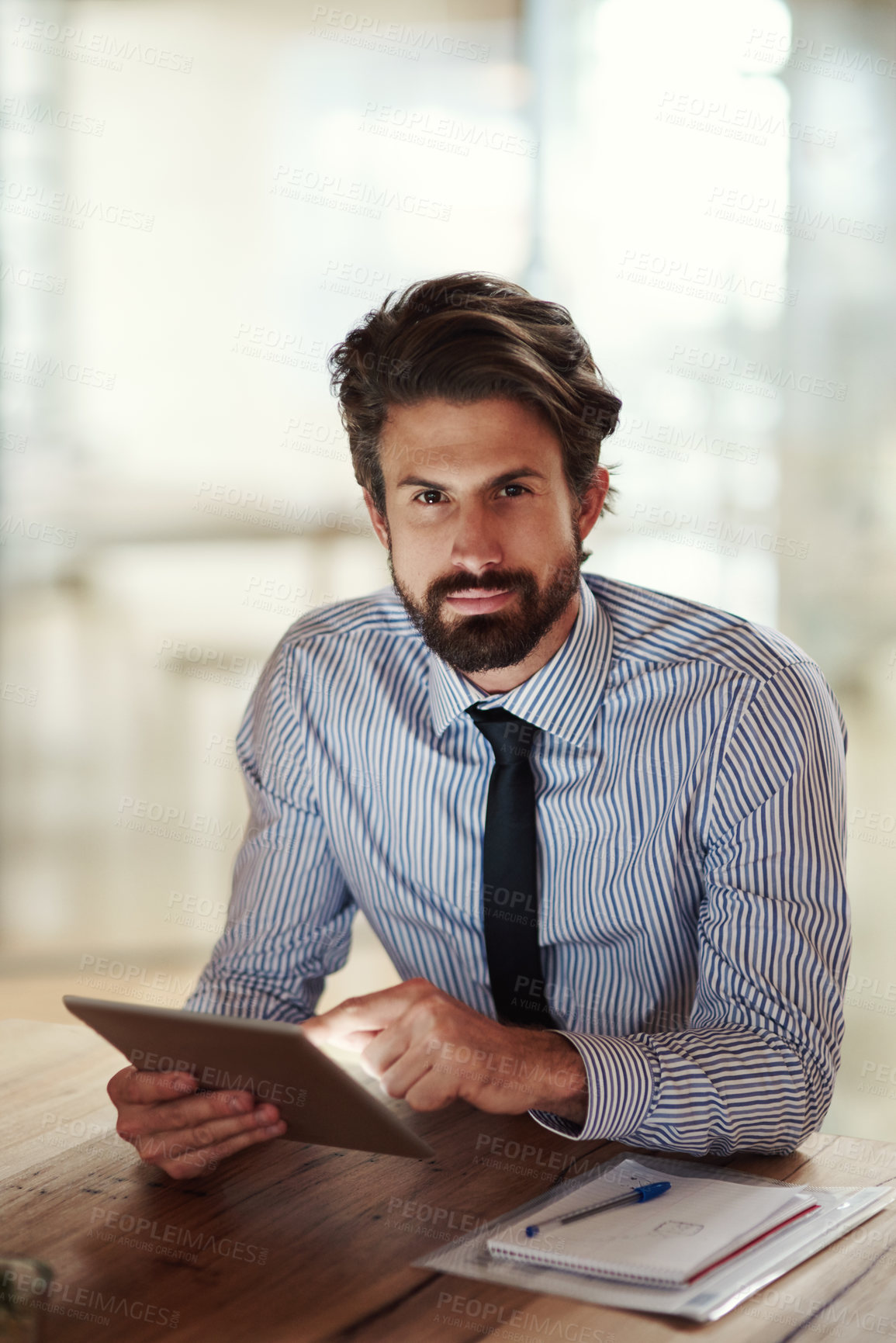 Buy stock photo Shot of a businessman using a digital tablet