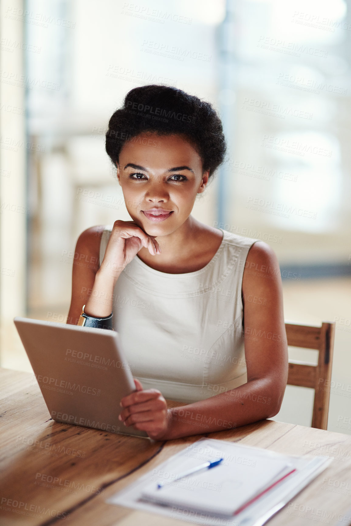 Buy stock photo Shot of a businesswoman using a digital tablet in an office