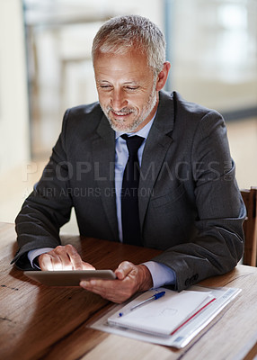 Buy stock photo Shot of a businessman using a digital tablet