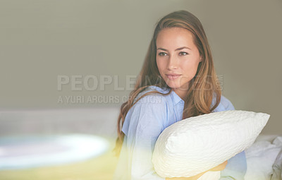 Buy stock photo Shot of an attractive young woman hugging a pillow in her bedroom