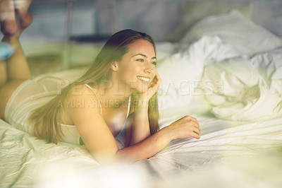 Buy stock photo Shot of an attractive young woman relaxing in her bedroom in the morning