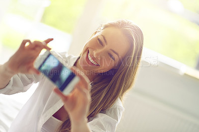 Buy stock photo Shot of a young woman taking a morning selfie in her bedroom