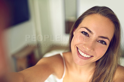 Buy stock photo Shot of a young woman taking a morning selfie at home