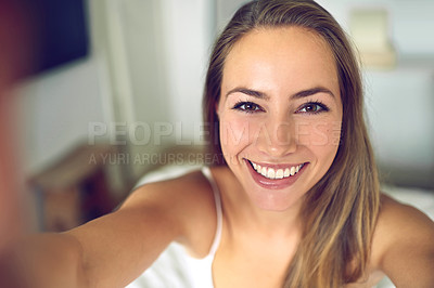 Buy stock photo Shot of a young woman taking a morning selfie at home
