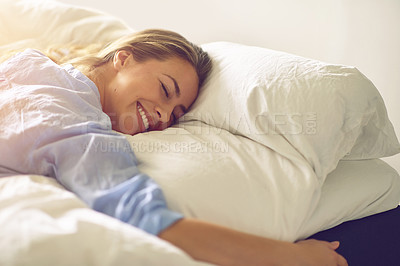 Buy stock photo Shot of a carefree young woman relaxing in her bedroom in the morning