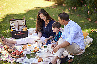 Buy stock photo Shot of a family enjoying a picnic together