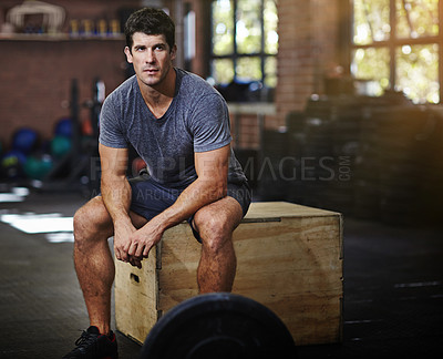 Buy stock photo Portrait of a young man taking a break from working out in a gym