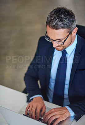 Buy stock photo Office, laptop and businessman typing at desk with research, legal advice and networking at law firm. Lawyer, attorney or mature man with computer, email and consulting with online feedback above