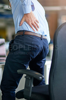 Buy stock photo Shot of a businessman suffering from back pain