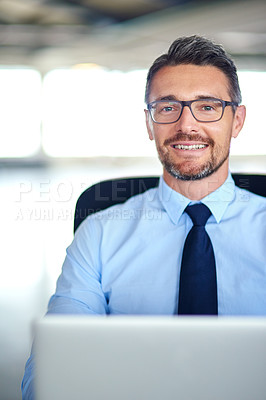 Buy stock photo Portrait of a businessman using a laptop in the office