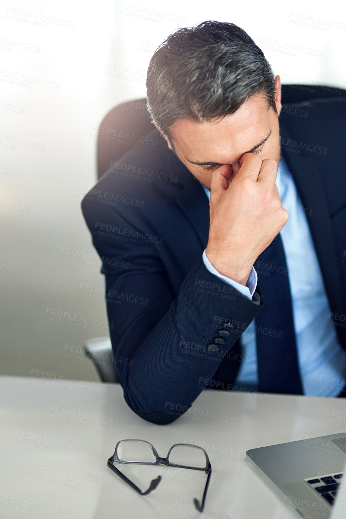Buy stock photo Shot of a businessman experiencing stress at the office
