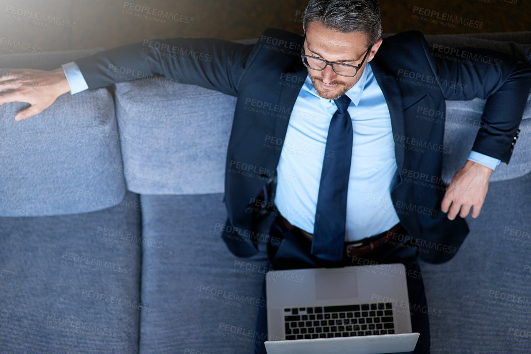 Buy stock photo Sofa, airport and above of businessman on laptop for commute, travel and journey for work conference. Corporate, top view and person on computer in lobby for website, flight schedule and internet