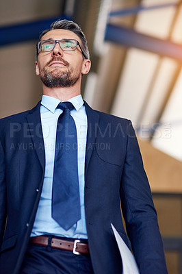 Buy stock photo Shot of a confident businessman in an office