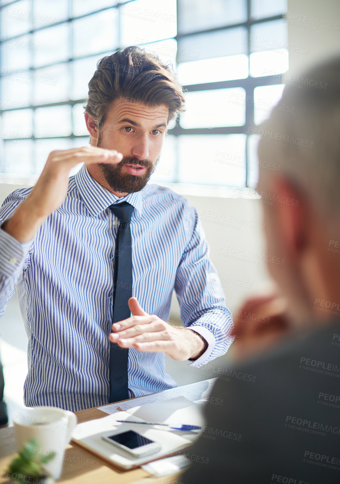 Buy stock photo Cropped shot of two businessmen talking in the office