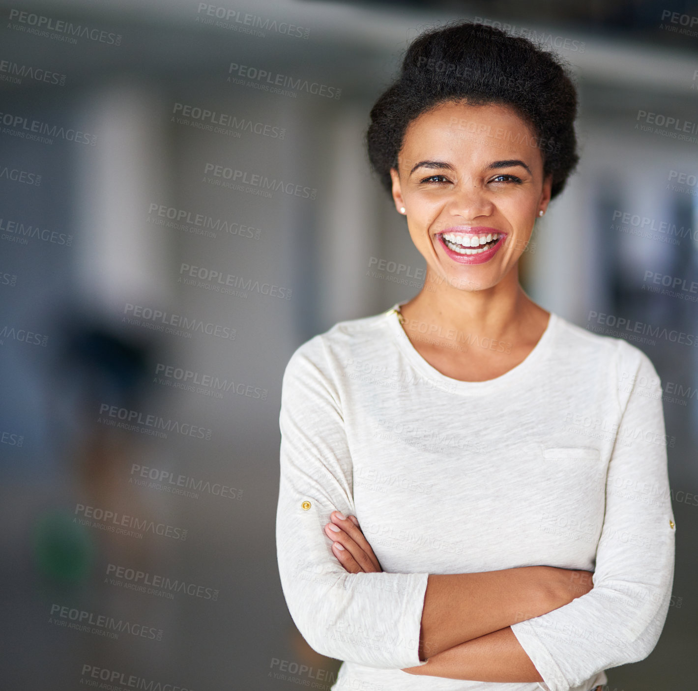 Buy stock photo Cropped portrait of a young businesswoman standing with her arms folded in the office