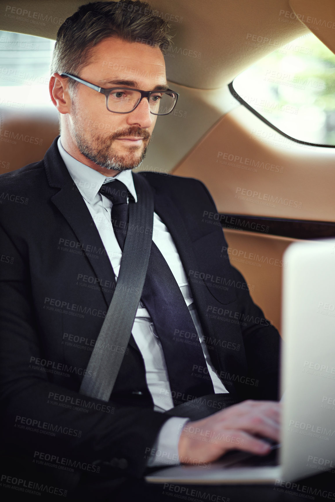 Buy stock photo Cropped shot of a businessman in the backseat of a car