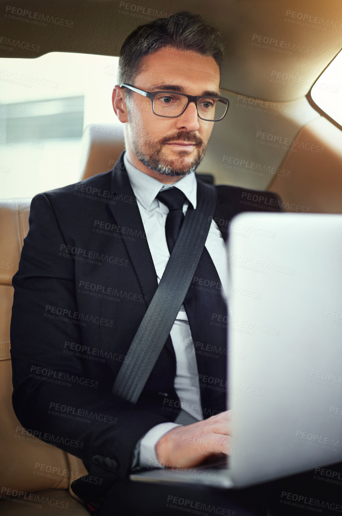 Buy stock photo Businessman, typing and laptop in car for travel with online project research, writing email and work commute. Male person, ceo and computer in motor for chauffeur service, reading report and admin