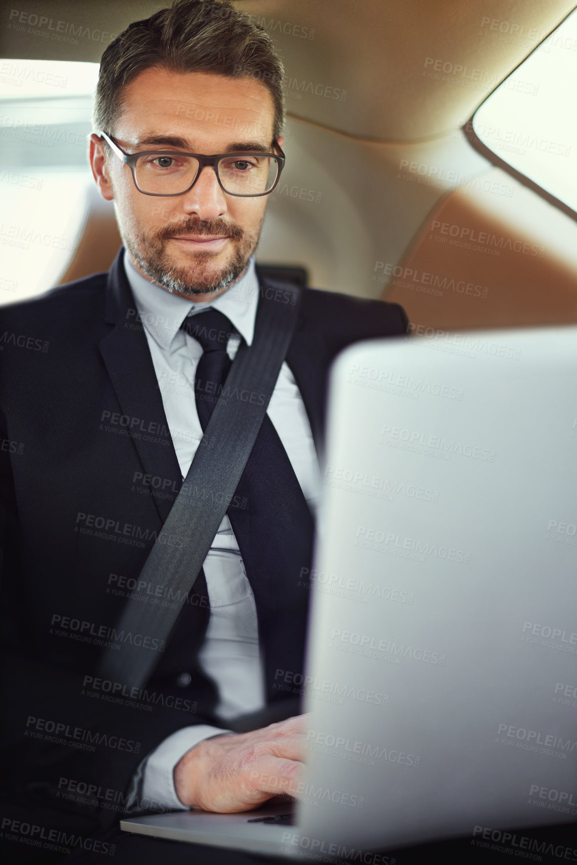 Buy stock photo Cropped shot of a businessman in the backseat of a car