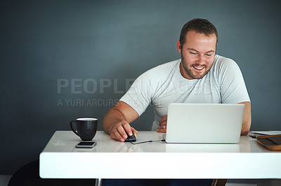Buy stock photo Cropped shot of a young man working on his laptop