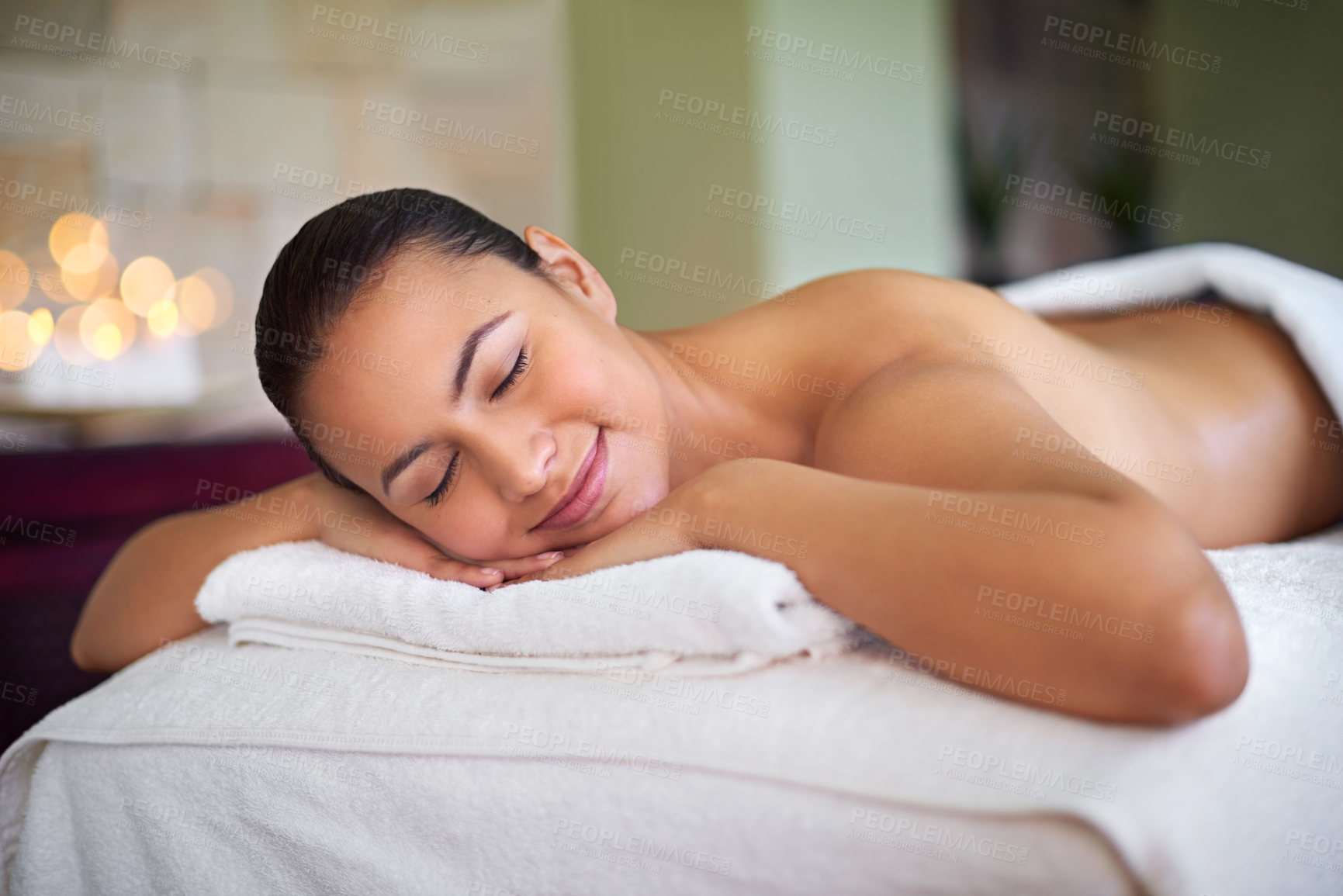 Buy stock photo Spa, woman or smile on bed for relax, comfort or ready for therapeutic massage. Luxury, happy or person at resort for treatment, zen or stress free environment for rest or rejuvenation in hospitality