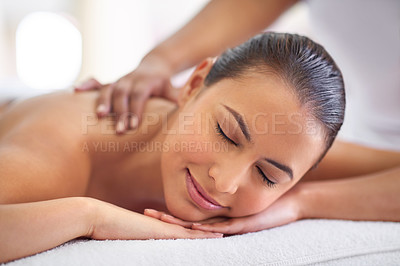 Buy stock photo Shot of a young woman enjoying a back massage at a spa