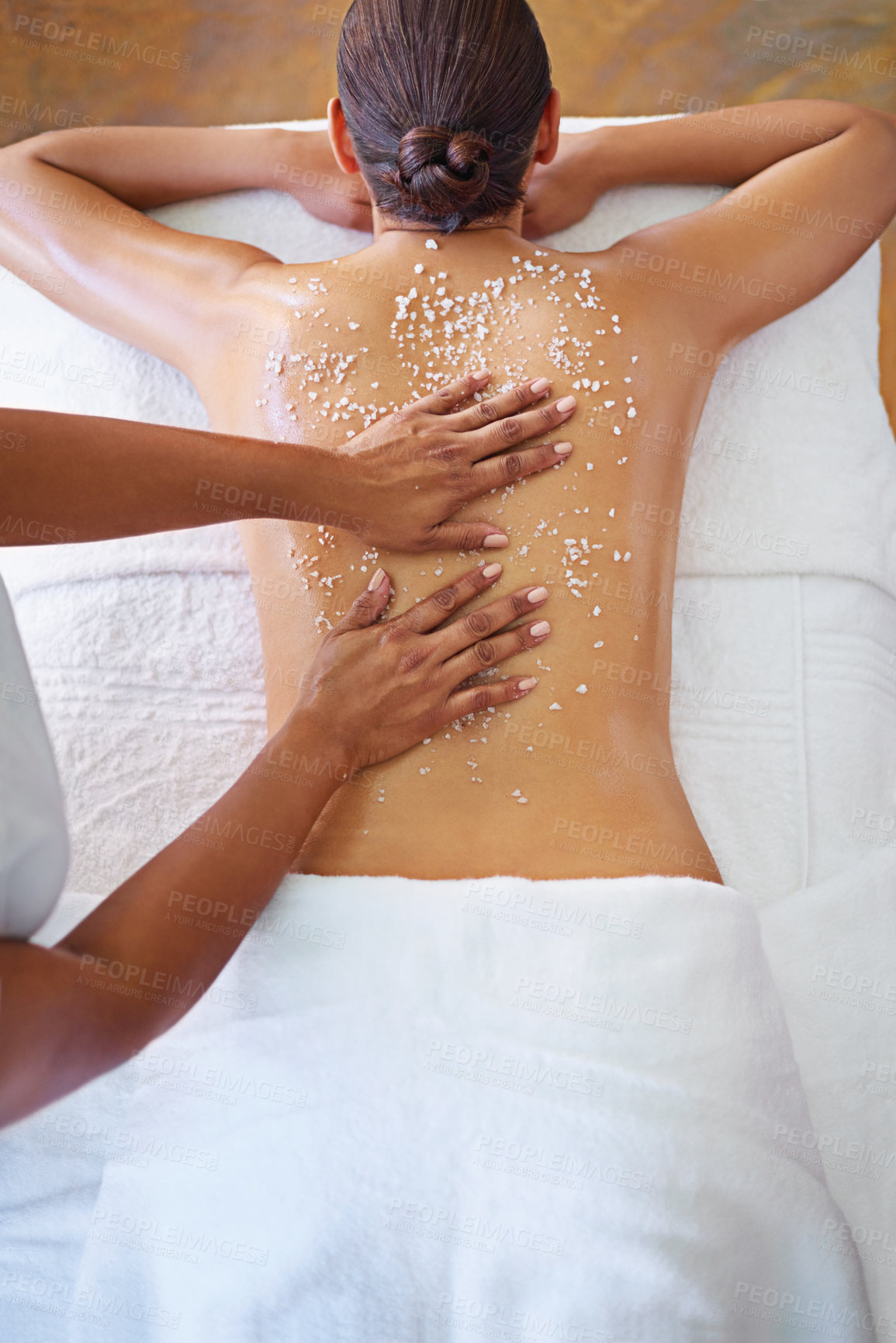 Buy stock photo Rearview shot of a woman getting an exfoliation treatment