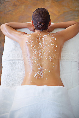 Buy stock photo Rearview shot of a woman getting an exfoliation treatment