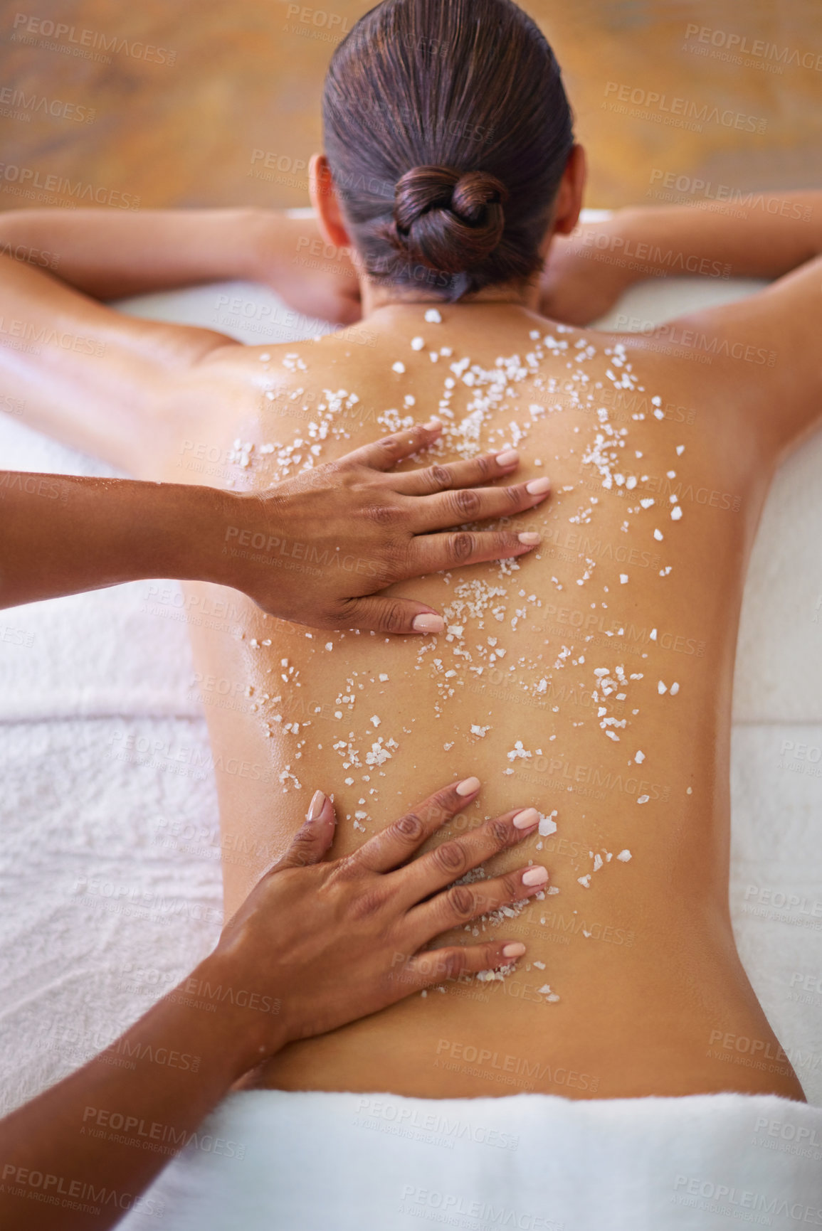 Buy stock photo Rearview shot of a woman getting an exfoliation treatment