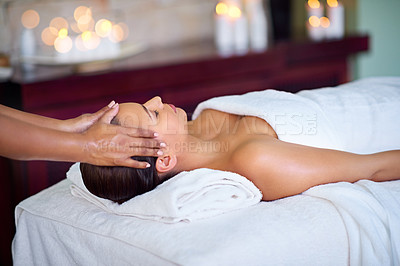 Buy stock photo Shot of a young woman receiving a head massage at a spa