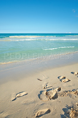 Buy stock photo Beach, shoreline or footsteps with sand, blue sky or paradise for vacation or environment to relax. Brazil, coast or nature view of water, sea and ocean in Rio de Janeiro with destination for travel